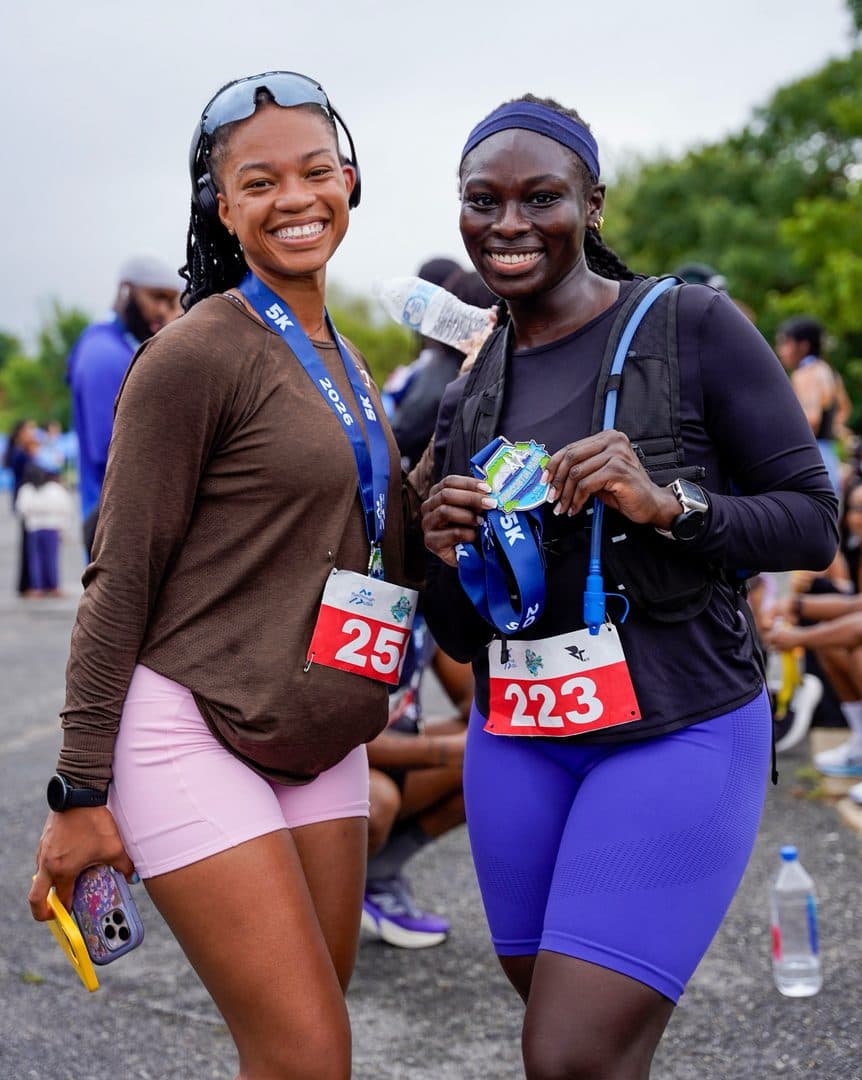 Two RunThrough USA finishers with their medals at Anacostia Park