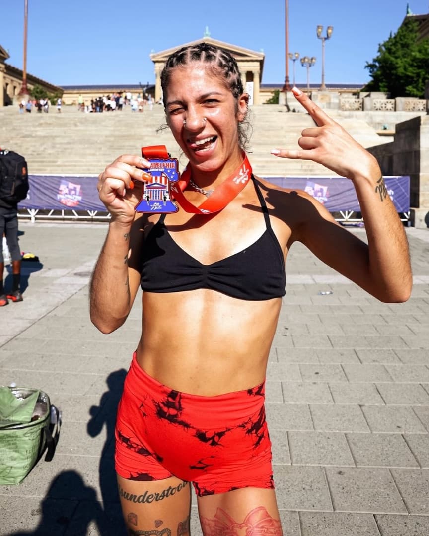 A Philadelphia Labor Day finisher with their medal at the Rocky Steps